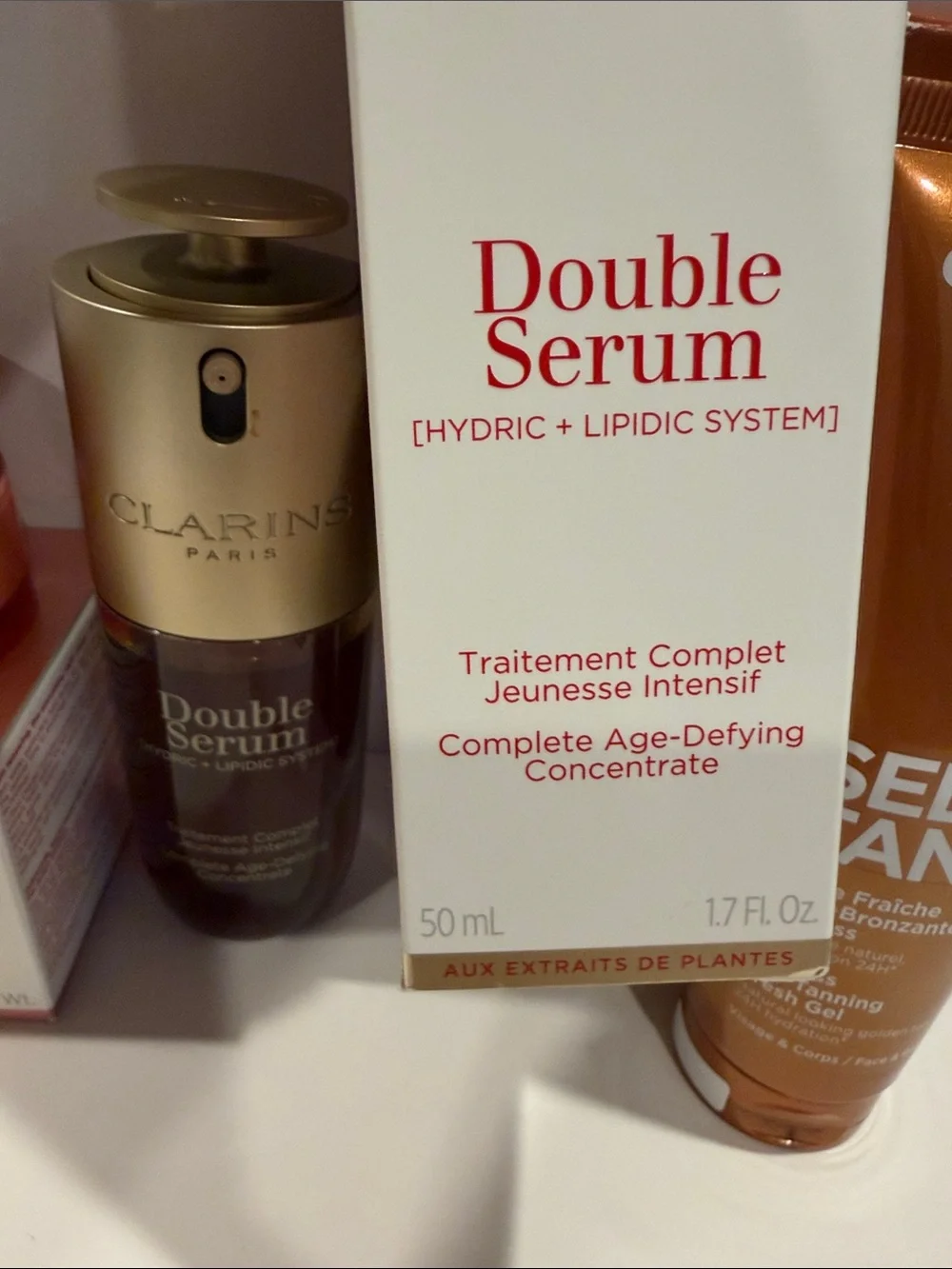 Clarins skincare set in pink, gold, white, and bronze